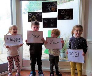 Happy New Year sign held by children