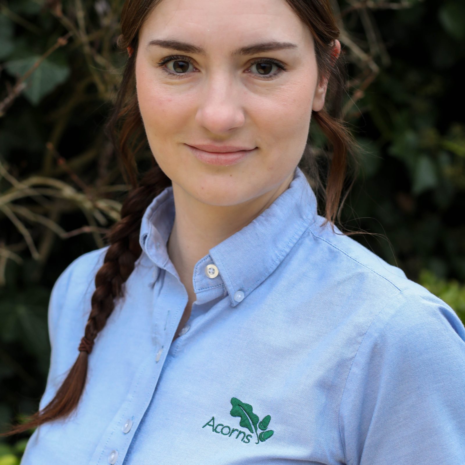 Acorns Nurseries A person with braided hair in a blue 